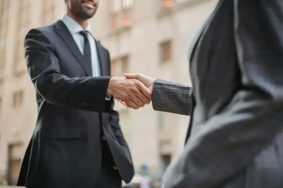 Two men shake hands